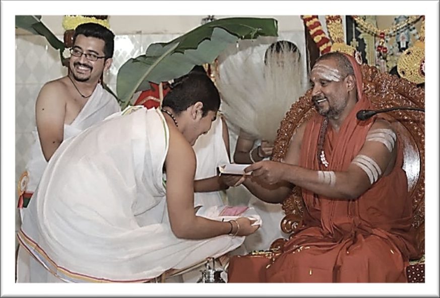 A young graduate receiving blessings from Sri Yogi